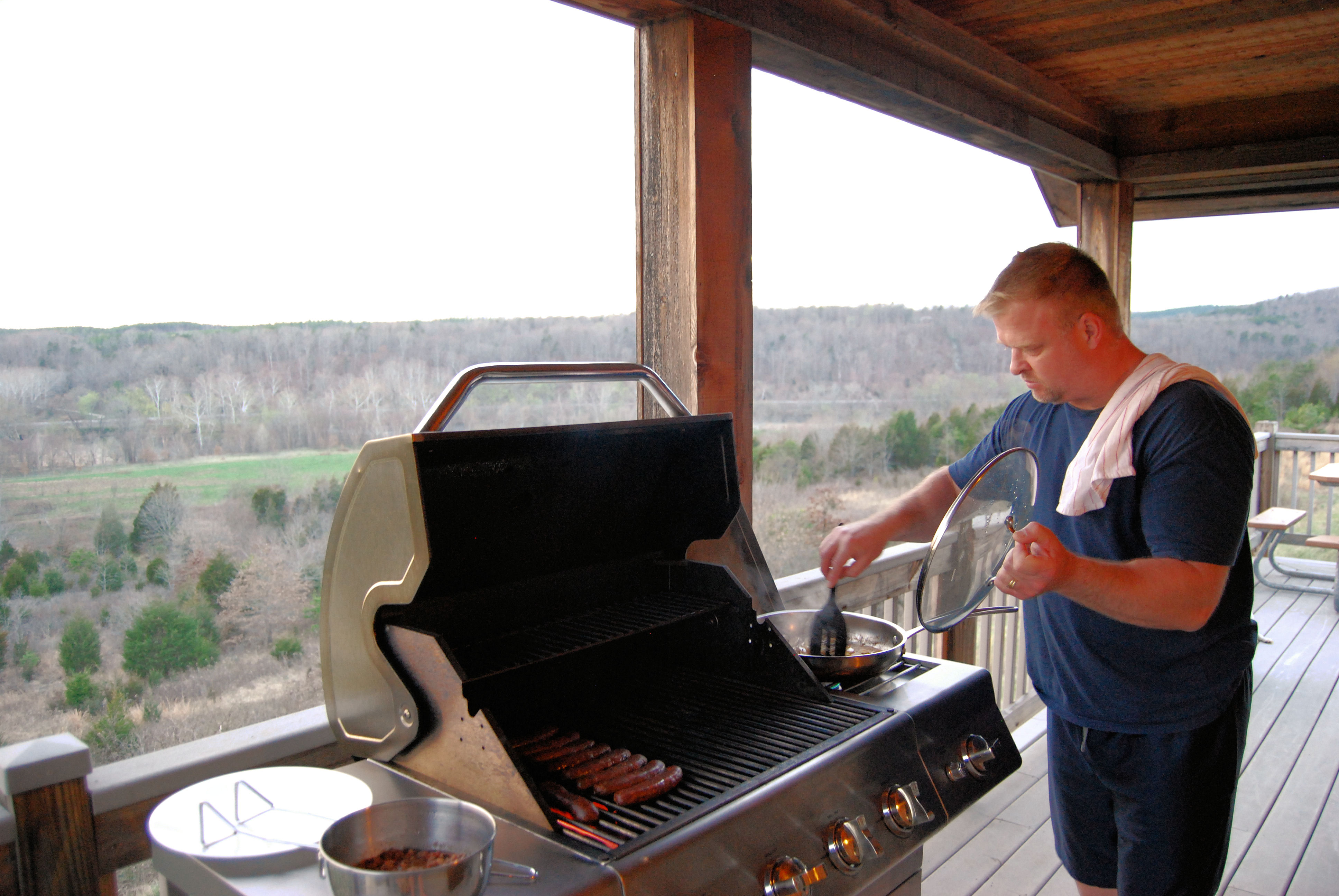 A man grilling on a modern BBQ deck area