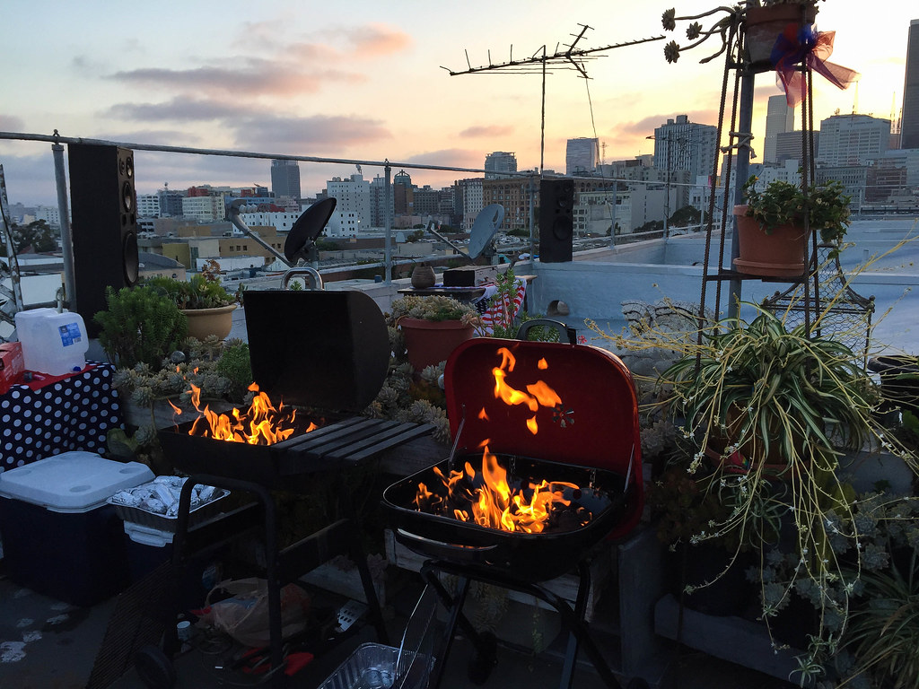 Two fired up charcoal BBQ on a rooftop garden