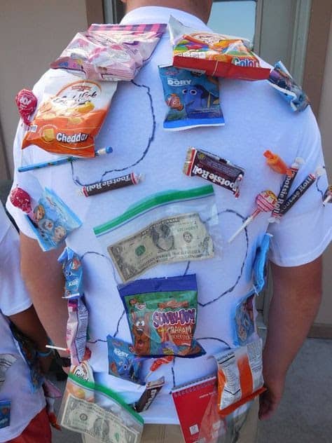 A man playing human pinata while wearing a shirt with prizes on it