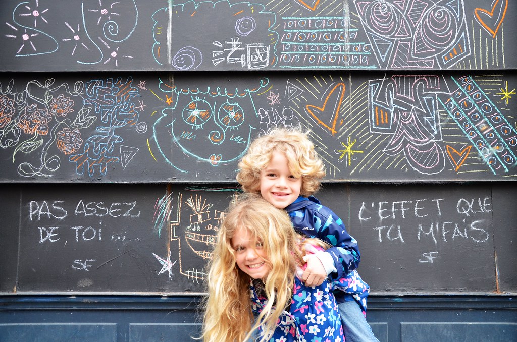 Garden blackboard with colourful doodles and kids posing in front