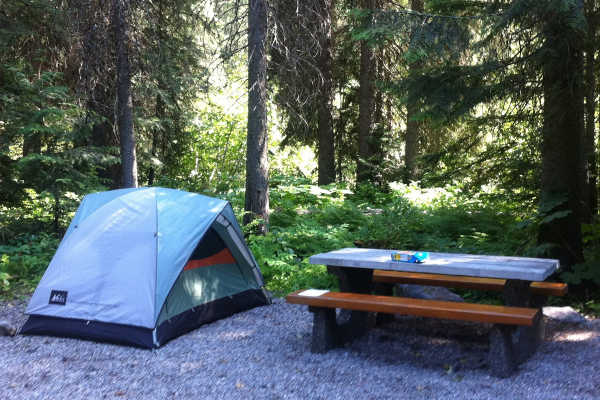 Camping tent with a picnic table nearby