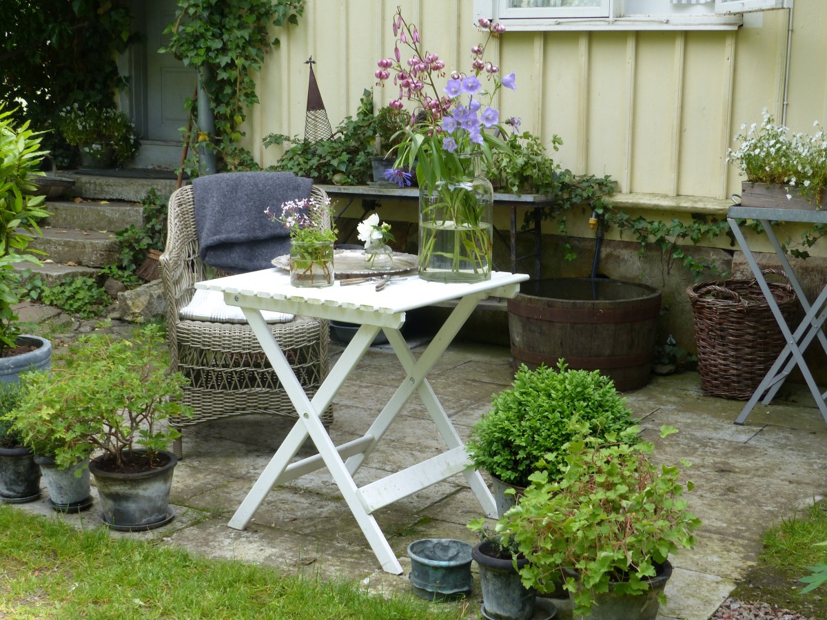 Corner seating spot with a bistro table and rattan chair
