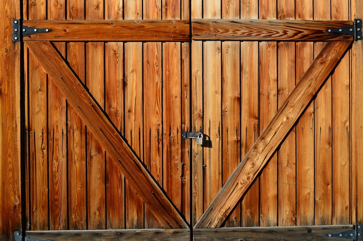 Modern barn-like garden gate with padlock