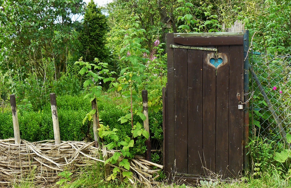 Woven rattan vegetable garden gate with old door
