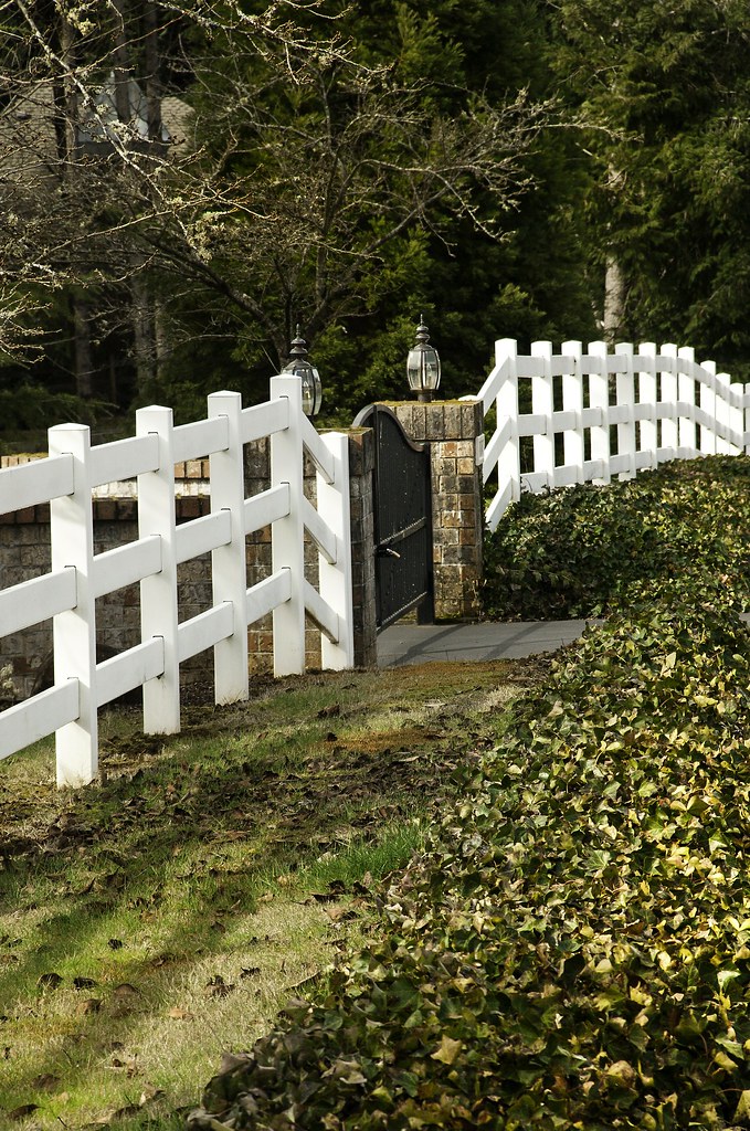 White picket fence and iron gate in the middle