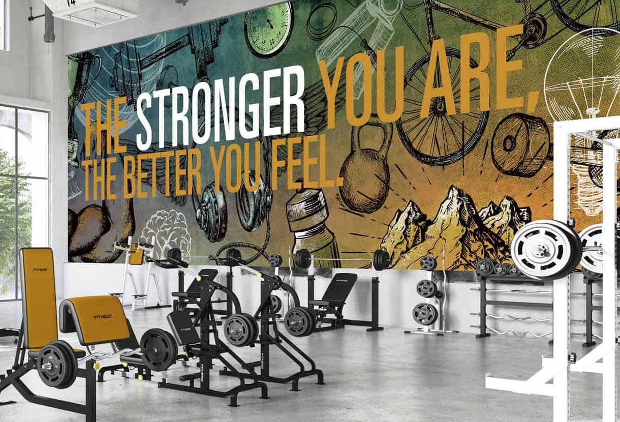 A certain wall in a gym with wall graphics and murals for extra inspiration