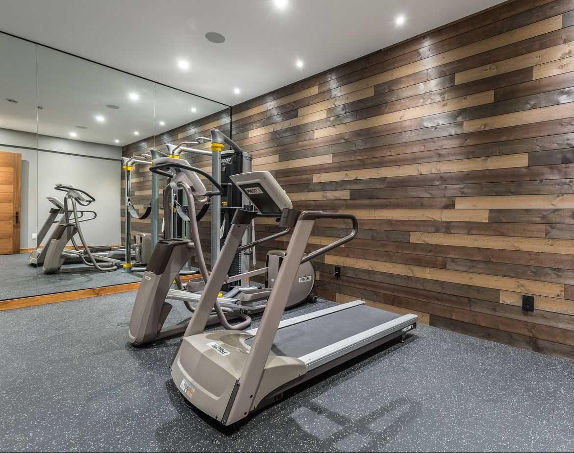 Wooden and bamboo wall accents in a modern gym setup