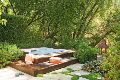 Garden spa set-up surrounded by greens and trees