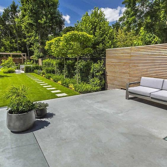 Concrete deck and grass with comfy outdoor seating