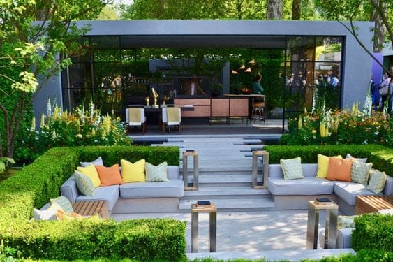 Sunken seating area and bar in a modern garden setting