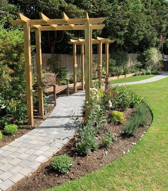A bench and a winding path dividing the garden space