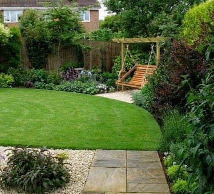 A simple garden with a wooden backyard swing