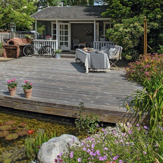 Huge rustic deck with a traditional house