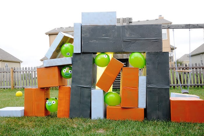 Giant angry birds made of cardboard boxes and green balloons