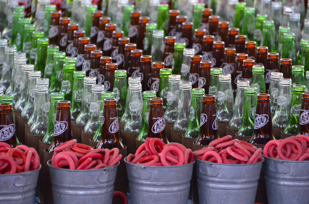Lined glass bottles with pails full of ring toss