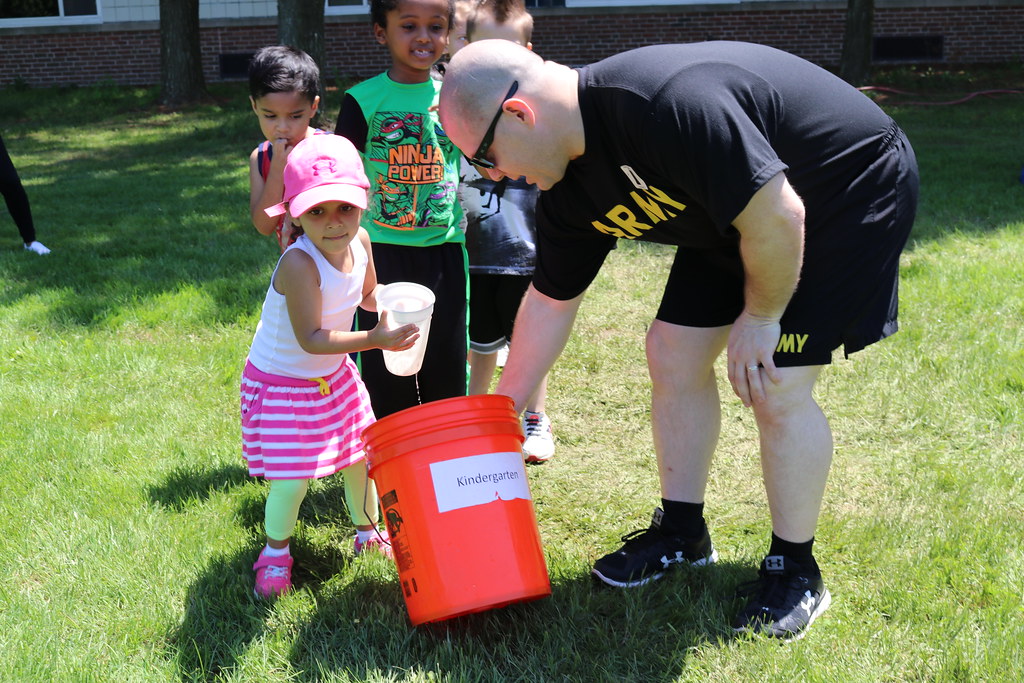 A team of kids playing "fill the bucket" game