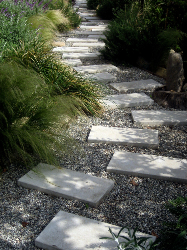 A path of concrete pavers meanders through the gardens