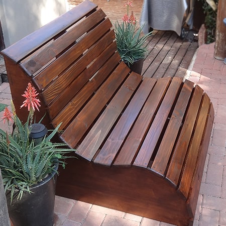 Slatted garden bench used as a garden love seat