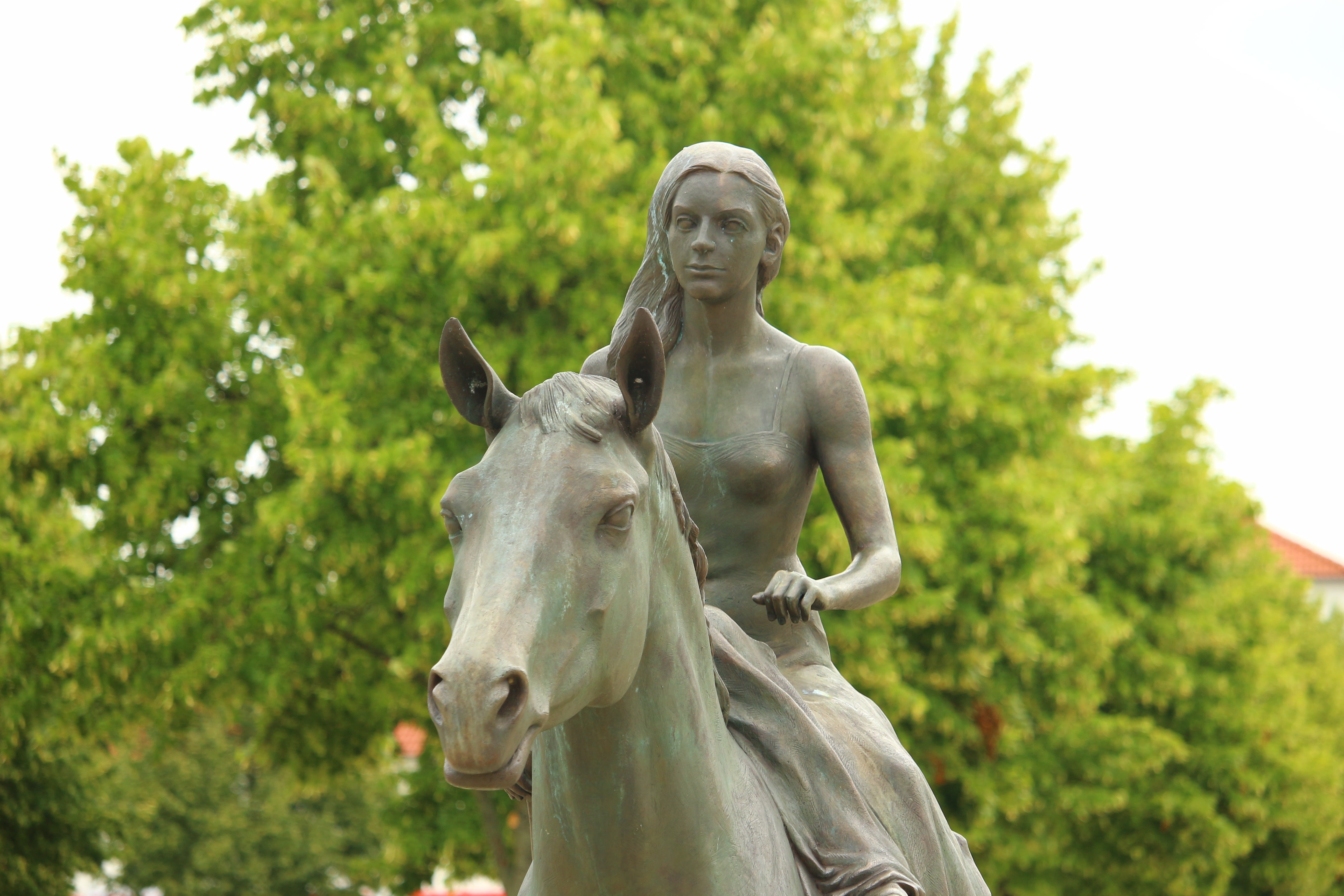 Woman riding on a horse statue