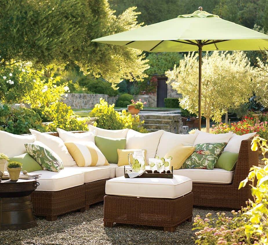 An L-shaped couch with stylish parasol for shade and privacy
