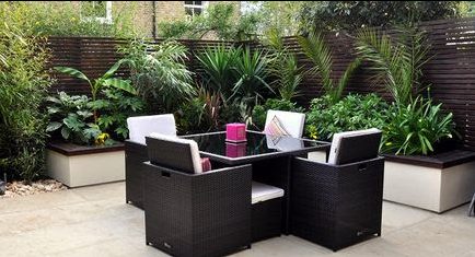 Modern urban jungle garden with synthetic rattan outdoor dining set