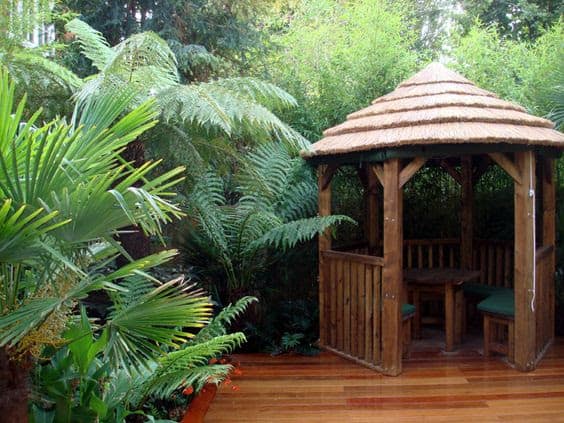 A thatched gazebo installed in a jungle-themed space