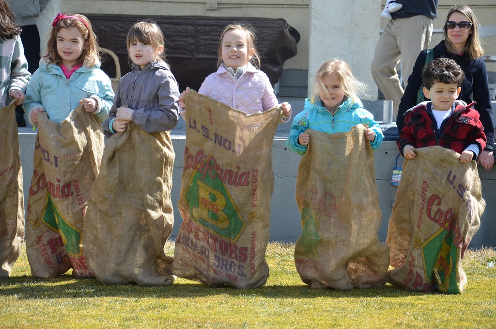Kids lining up for a second potato sack race