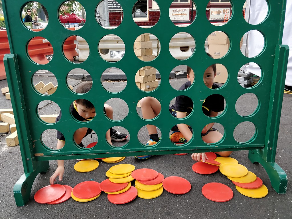 Two kids setting up giant Connect Four