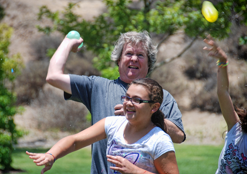 Family team playing water balloon toss