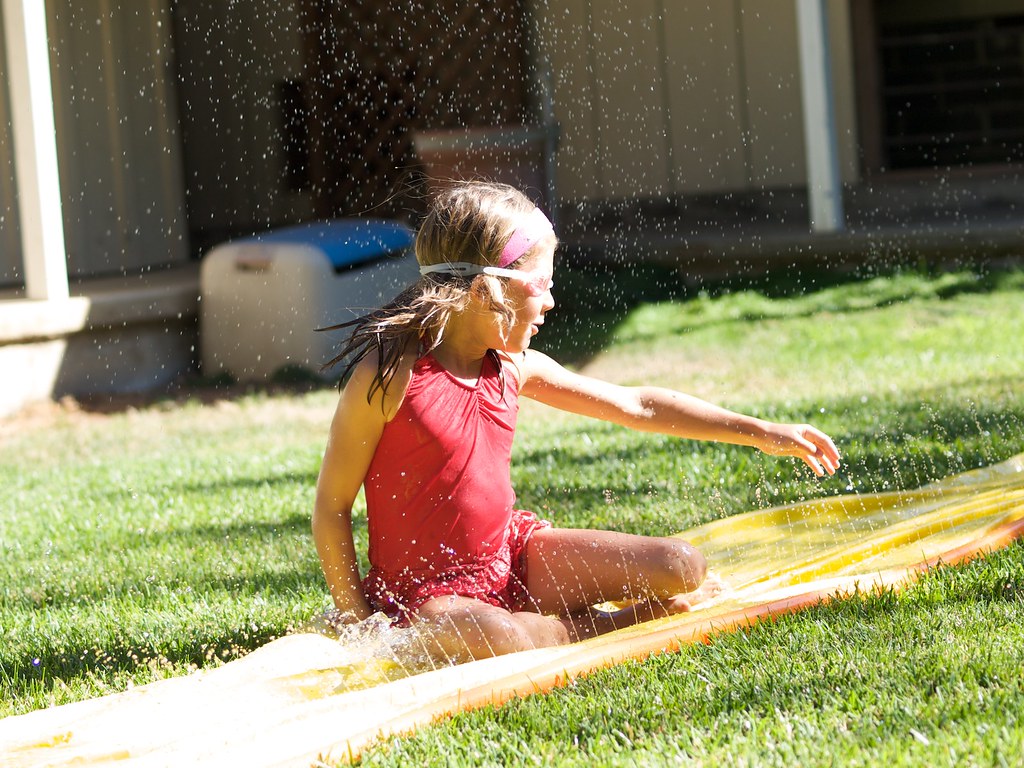 A kid in a slip and slide game
