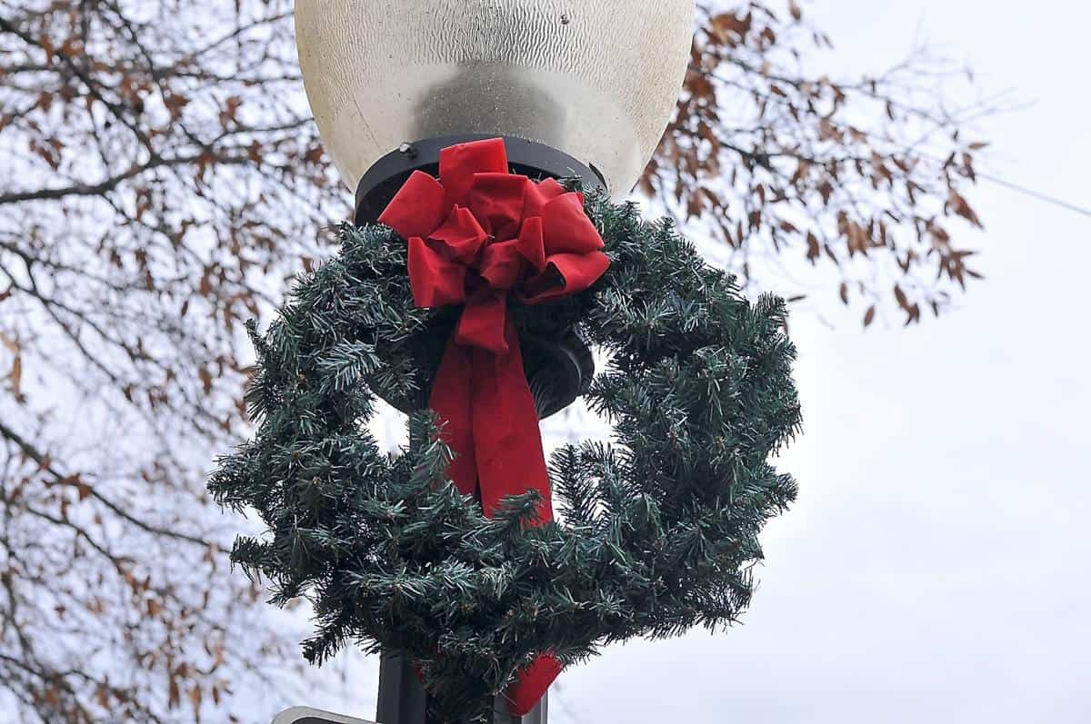 Christmas wreath with red ribbon on a lamp post
