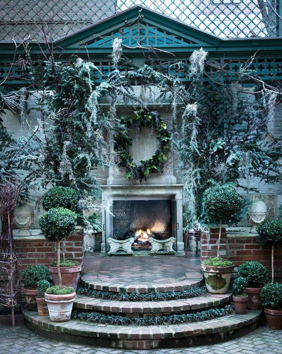 Outdoor fireplace full of holiday decorating treatment