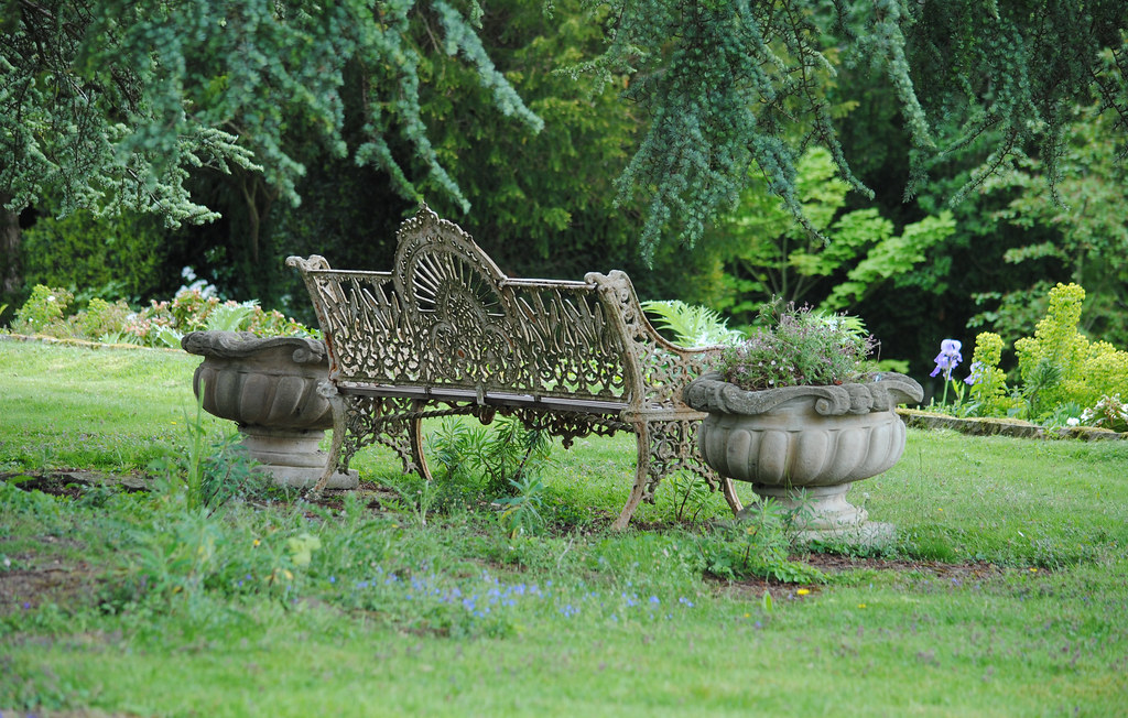 Victorian garden bench with urns on each side