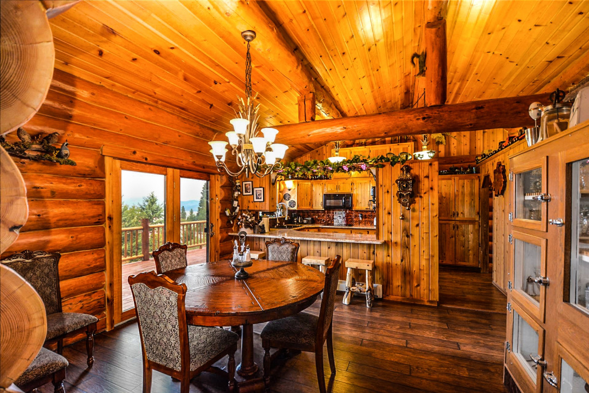 Log cabin kitchen and dining area with chandelier
