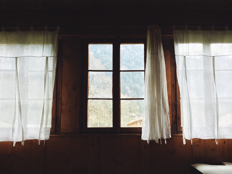 Log cabin windows with sheer curtains