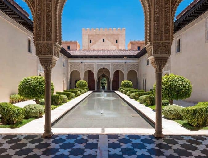 Symmetrical Moroccan garden with avenue of palms, edging the pool