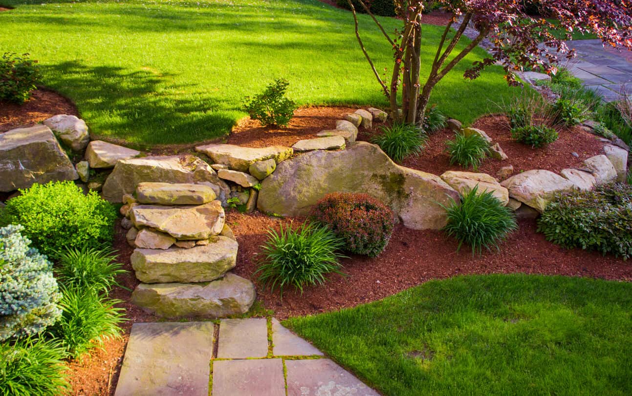 Boulder rocks in a tiered garden reflecting a cleaner and modern look
