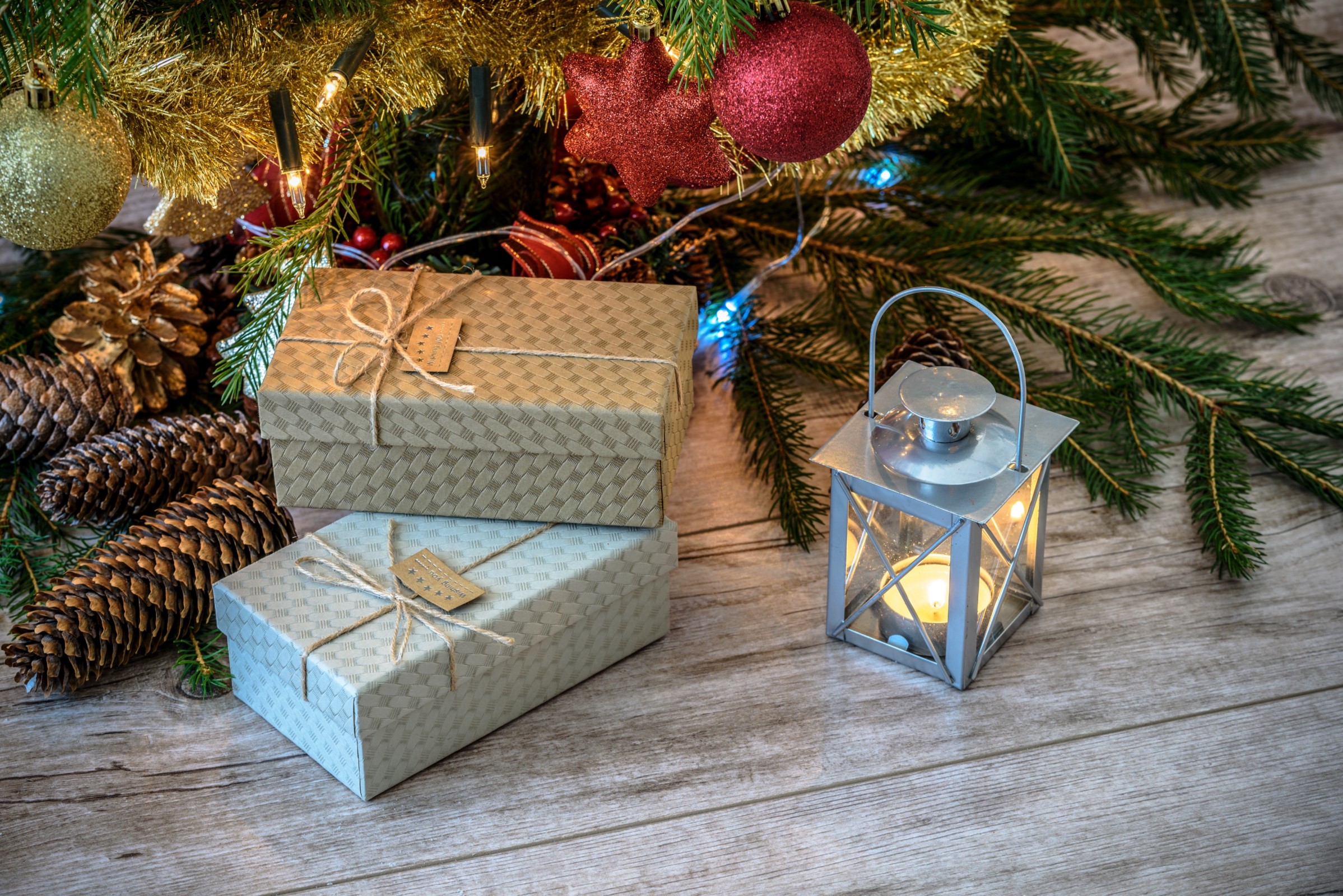 Christmas presents on the floor with lantern candle