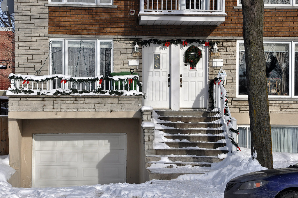 Porch railing with Christmas garlands