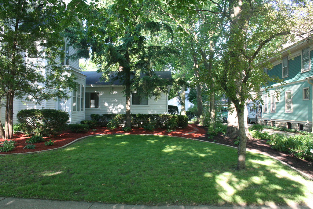 Shaded front yard with trees and lush lawn