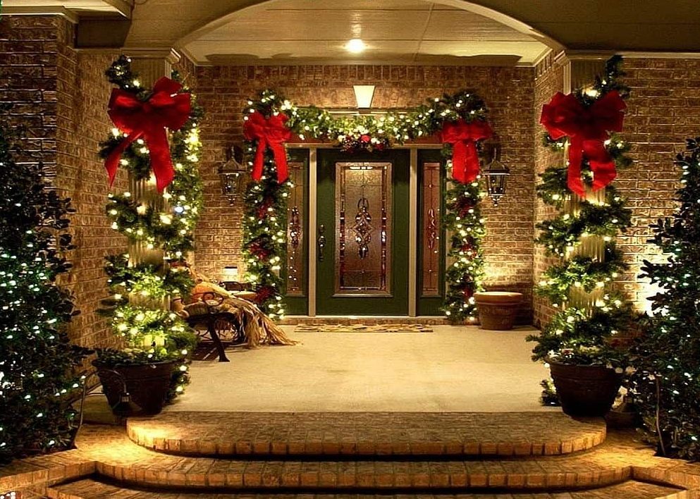 Main door decorated with Christmas lights and garlands
