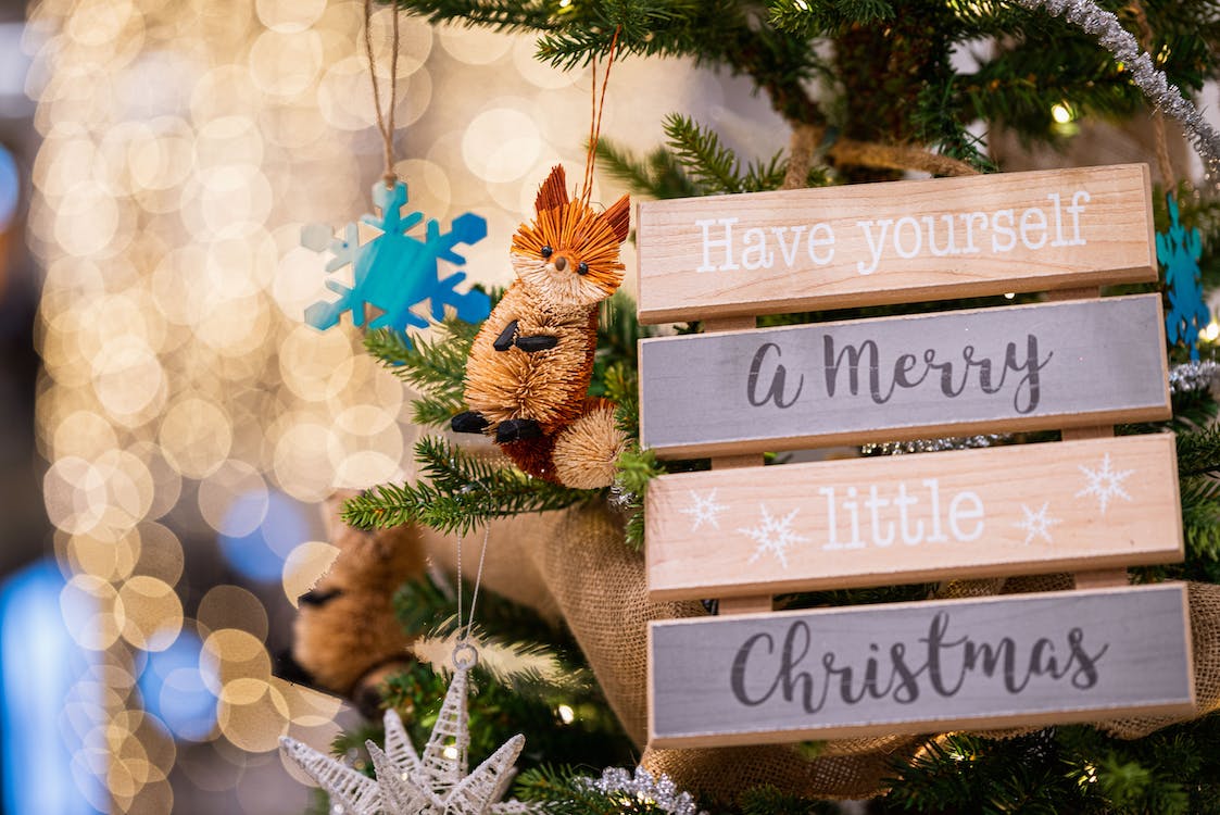 Christmas holiday signage hang on a Christmas tree