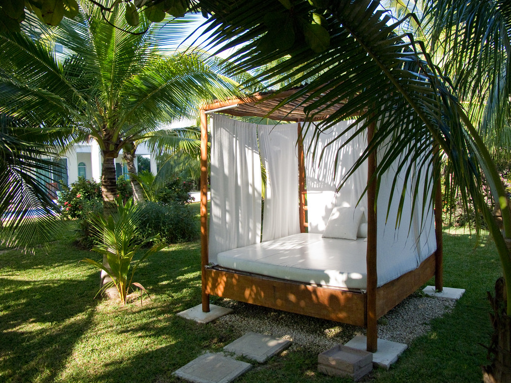Private wooden cabana with sheer curtains