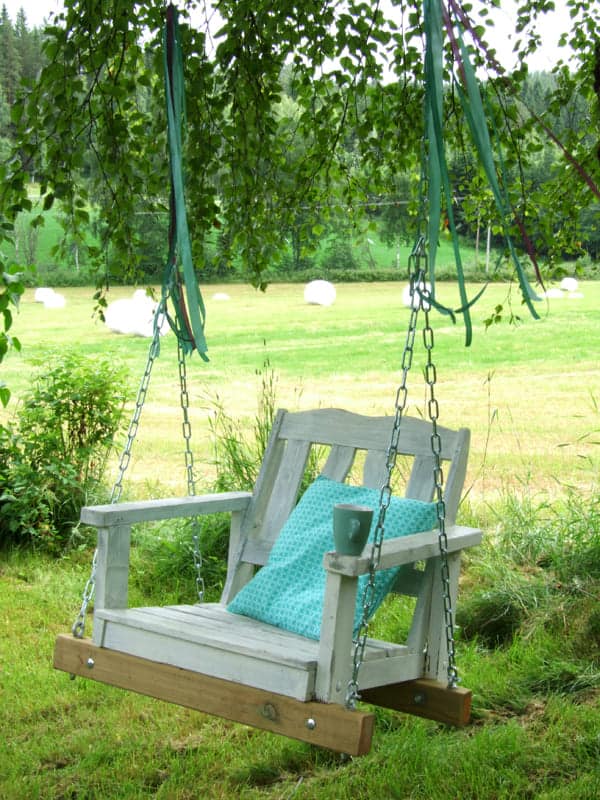 Old chair transformed into a garden swing