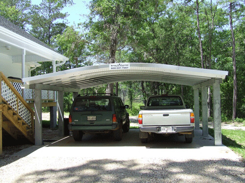 Domed shaped carport with two cars parked in