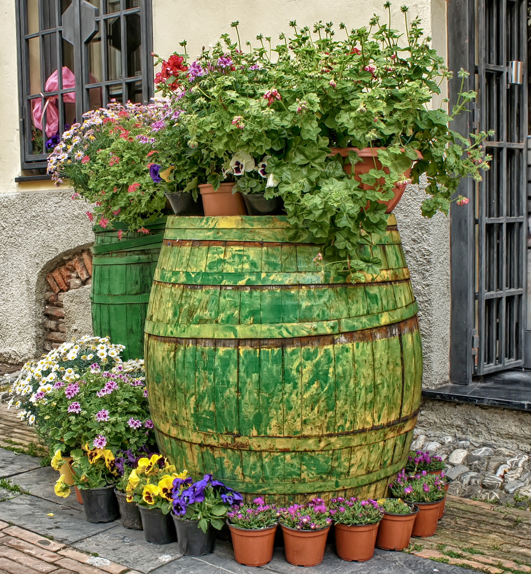 Green and yellow painted wine barrel planter