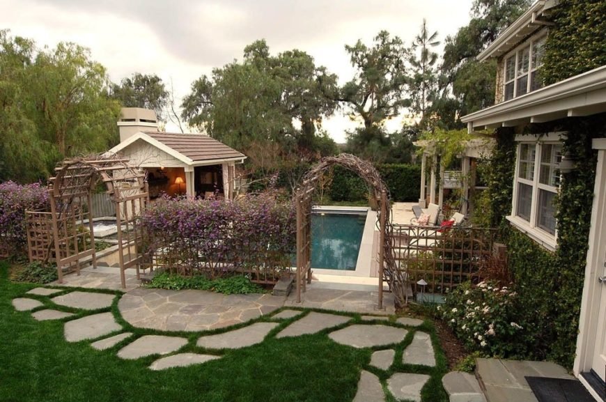 Backyard pool entrance with arbours
