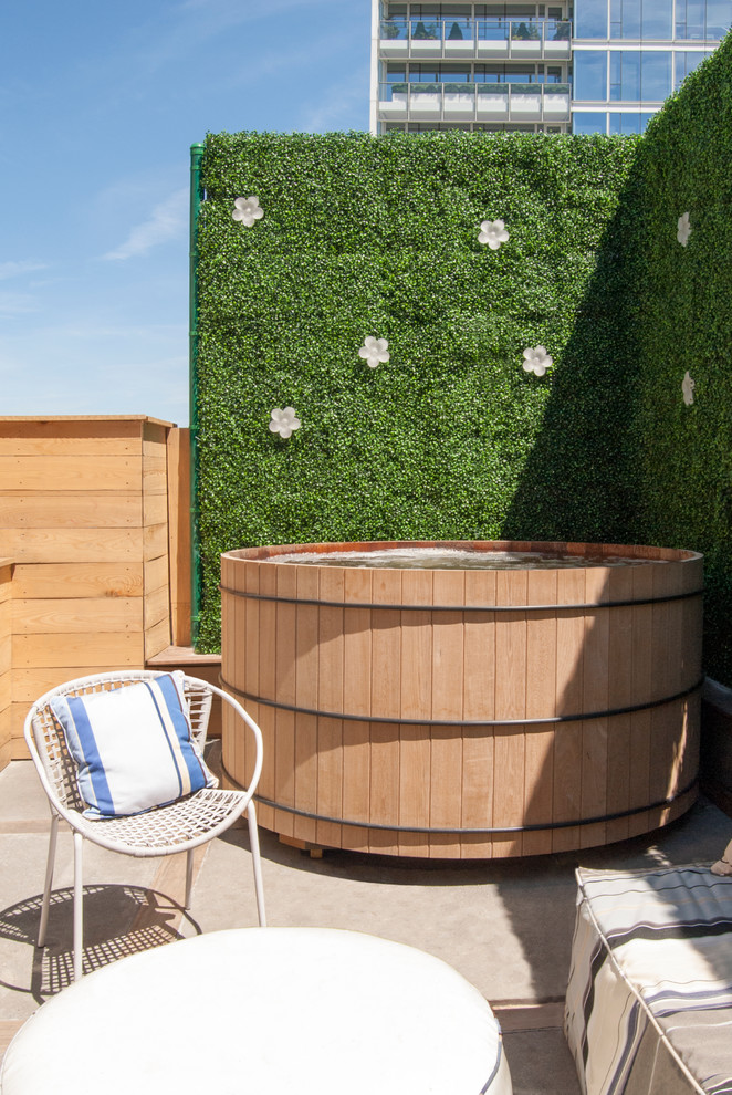 Outdoor hot tub with a green wall