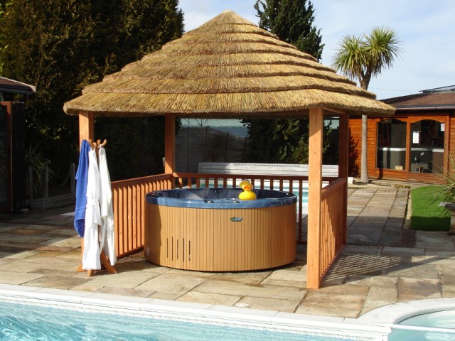 Inflatable hot tub with a beach side retreat-themed gazebo