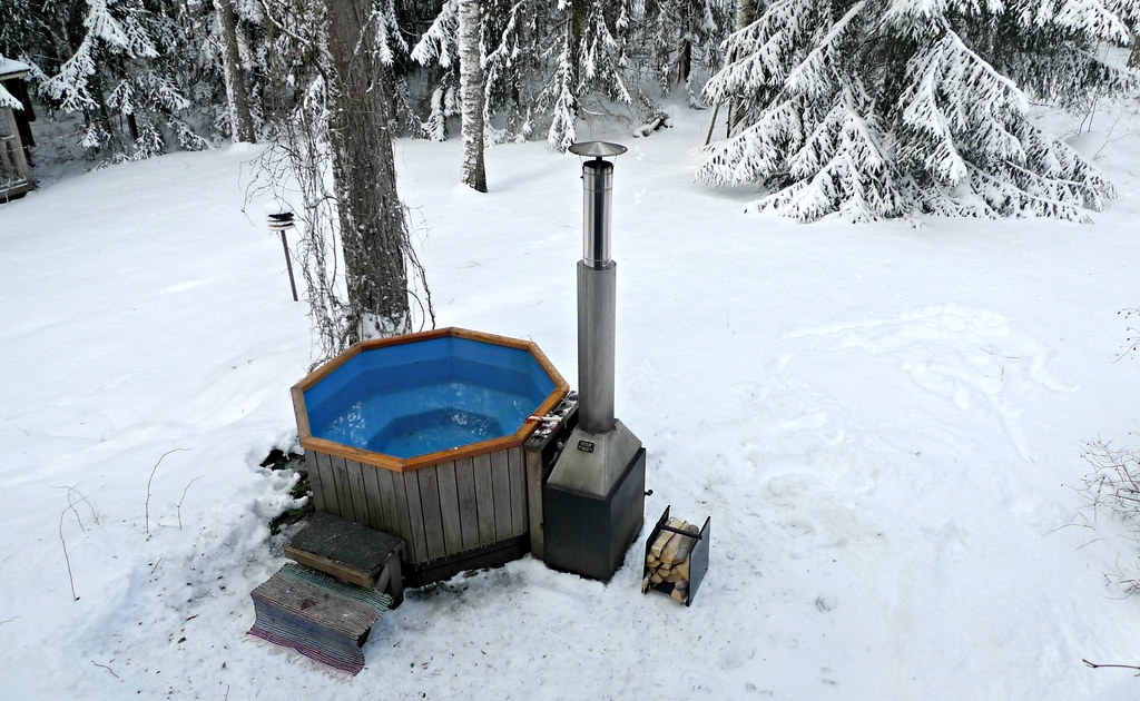 Heated outdoor hot tub in a winter garden
